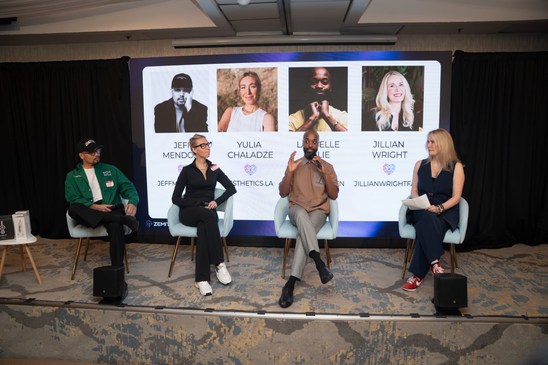 A panel of aesthetic industry experts speaking at a live Zemits event